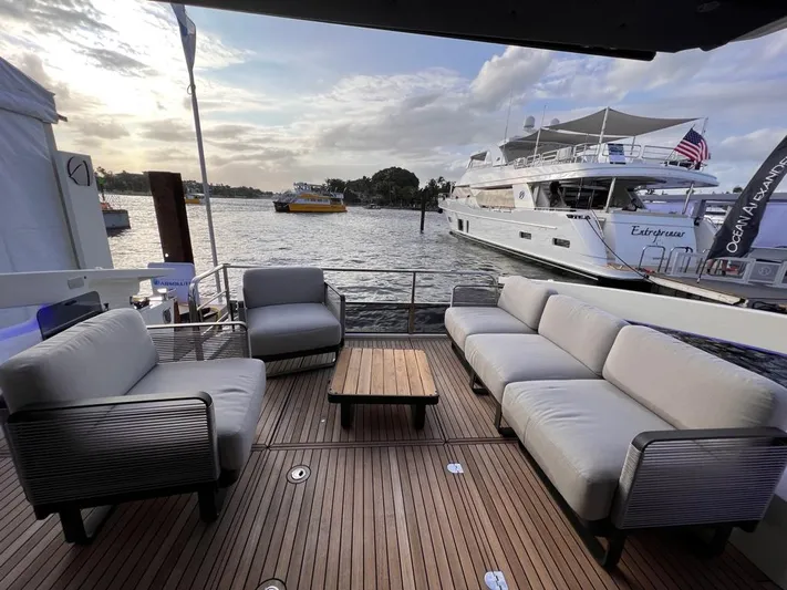  Yacht Photos Pics Luxury yacht deck with modern seating, overlooking a serene waterfront. Absolute 48 Coupe, 2025 model.