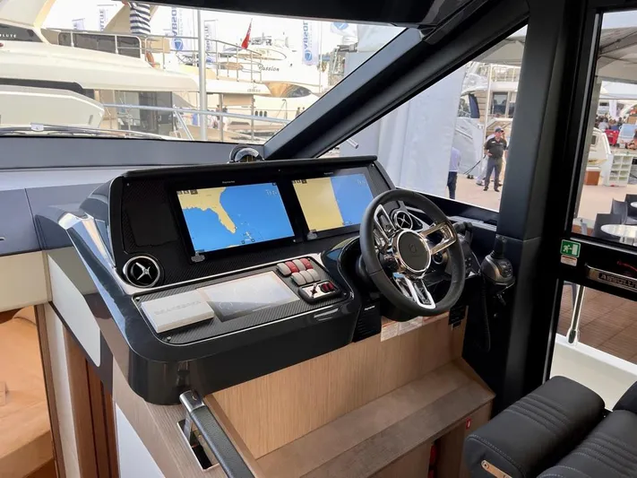  Yacht Photos Pics 2025 Absolute 48 Coupe yacht helm with modern navigation displays and steering wheel.