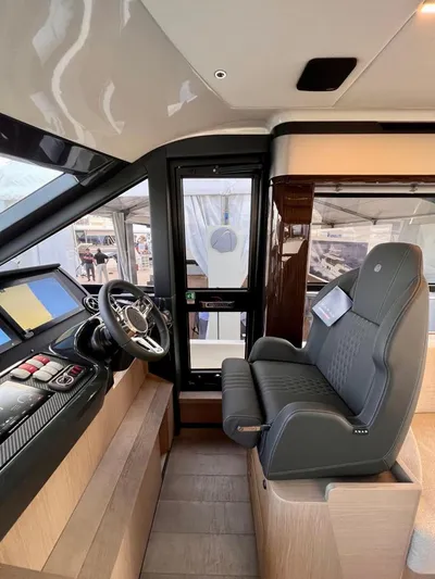  Yacht Photos Pics Interior of 2025 Absolute 48 Coupe yacht, featuring modern helm and luxurious seating.