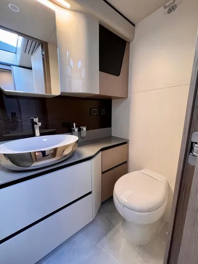  Yacht Photos Pics Modern bathroom in 2025 Absolute 48 Coupe yacht with sleek fixtures and elegant design.