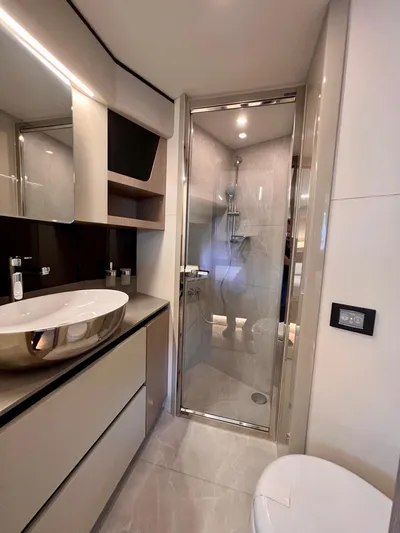  Yacht Photos Pics Luxurious bathroom in 2025 Absolute 48 Coupe yacht with modern fixtures and elegant design.