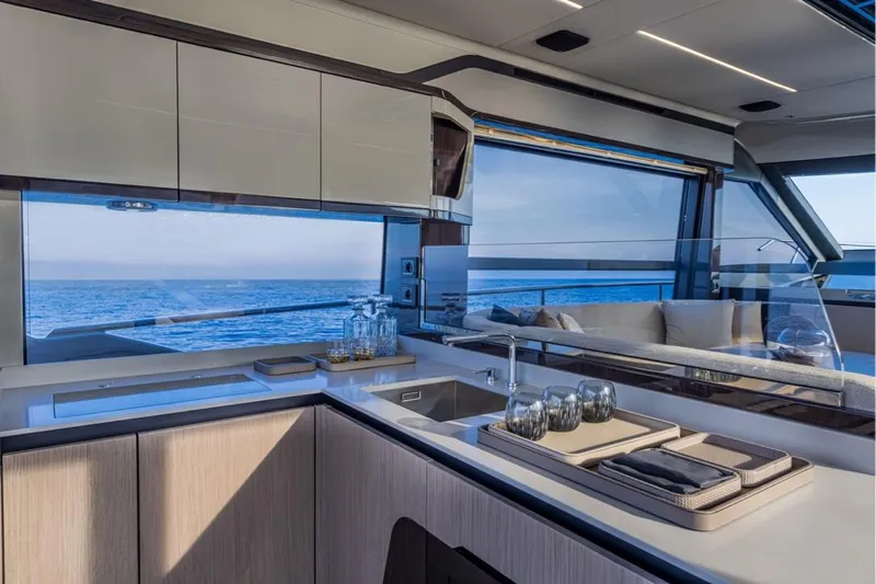  Yacht Photos Pics Modern kitchen interior on 2025 Absolute 48 Coupe yacht with ocean view.