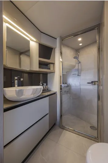  Yacht Photos Pics Luxurious bathroom in 2025 Absolute 48 Coupe yacht with modern fixtures and glass shower.