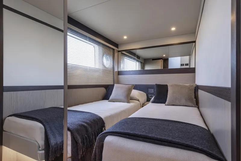  Yacht Photos Pics Interior of 2025 Absolute 48 Coupe yacht with twin beds and modern decor.