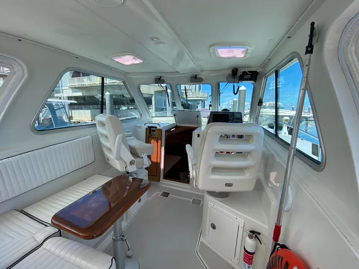 Chance Yacht Photos Pics 2007 Back Cove 29 boat interior with white seating and wooden table.