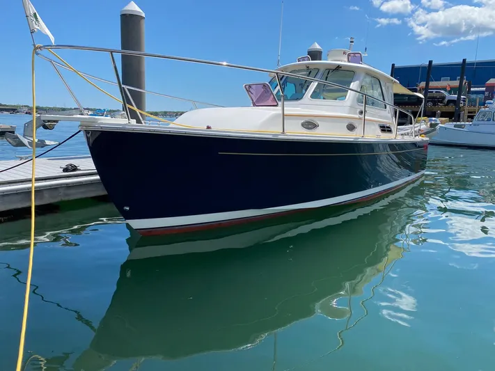 Chance Yacht Photos Pics 2007 Back Cove 29 boat docked in a marina under a clear blue sky.