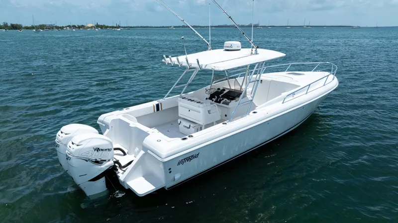  Yacht Photos Pics 1999 Intrepid 35 boat on calm water, featuring twin outboard engines.