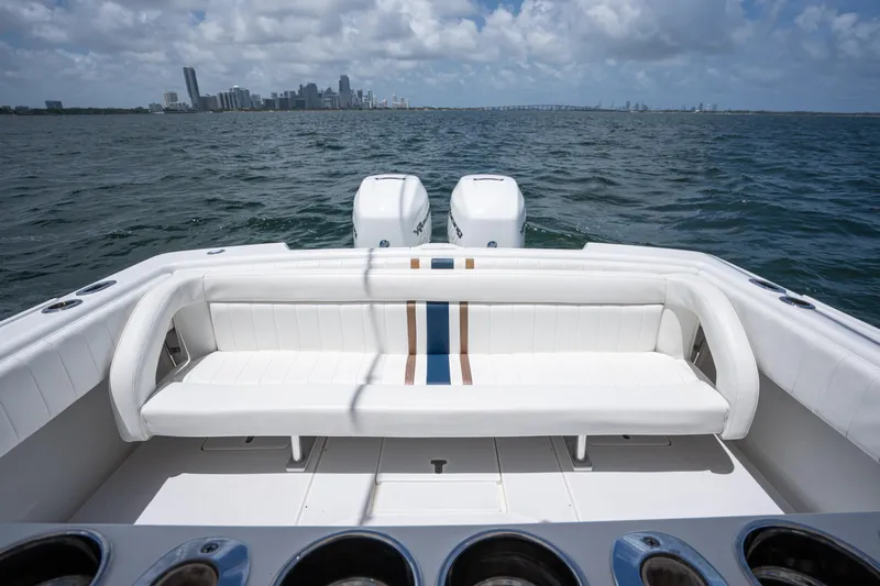  Yacht Photos Pics 1999 Intrepid 35 boat with white seating, ocean view, and city skyline in the background.