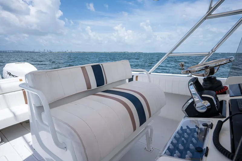  Yacht Photos Pics 1999 Intrepid 35 boat interior with striped seating and ocean view.