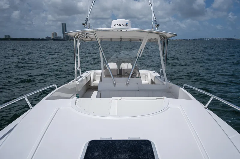  Yacht Photos Pics 1999 Intrepid 35 boat on water, featuring Garmin equipment, city skyline in background.