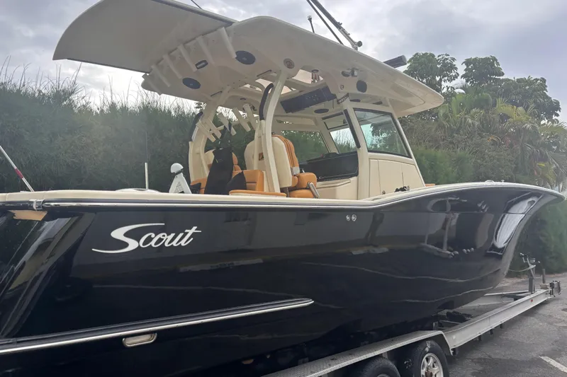  Yacht Photos Pics 2014 Scout 350 LXF boat on trailer, sleek black design, outdoor setting.