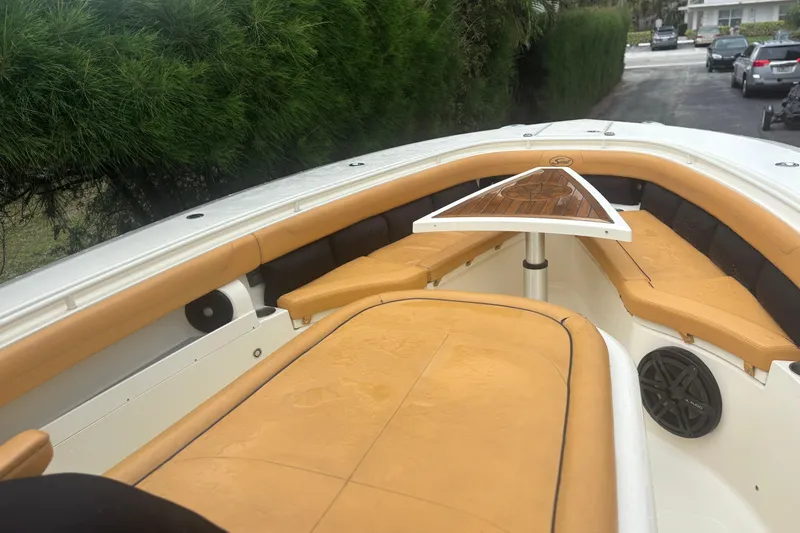  Yacht Photos Pics 2014 Scout 350 LXF boat interior with tan seating and wooden table.