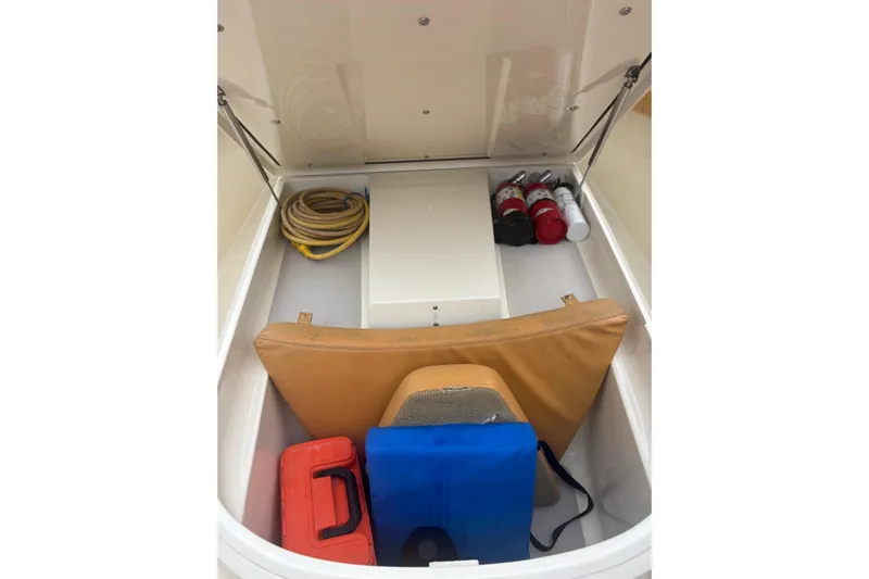  Yacht Photos Pics Storage compartment of 2014 Scout 350 LXF boat with safety equipment and supplies.