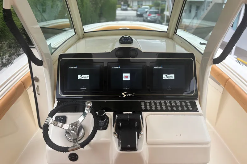  Yacht Photos Pics 2014 Scout 350 LXF boat dashboard with Garmin displays and steering wheel.