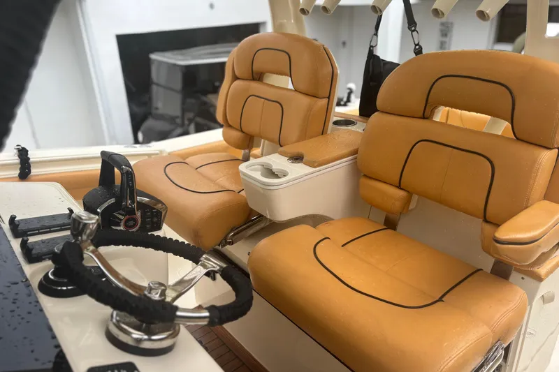  Yacht Photos Pics 2014 Scout 350 LXF boat interior with tan leather seats and steering wheel.