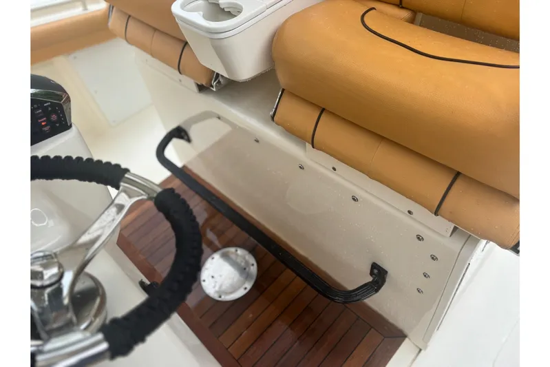  Yacht Photos Pics 2014 Scout 350 LXF boat interior with tan seating and steering wheel.