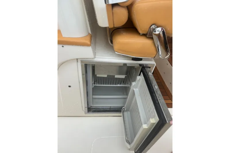  Yacht Photos Pics Open mini fridge on 2014 Scout 350 LXF boat, showcasing interior shelving.