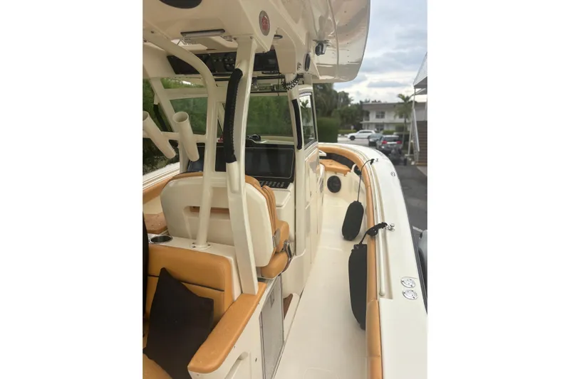  Yacht Photos Pics 2014 Scout 350 LXF boat interior with tan seating and modern dashboard.