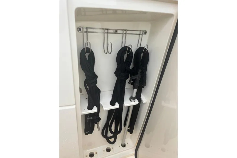  Yacht Photos Pics Storage compartment with black ropes and hooks on a 2014 Scout 350 LXF boat.
