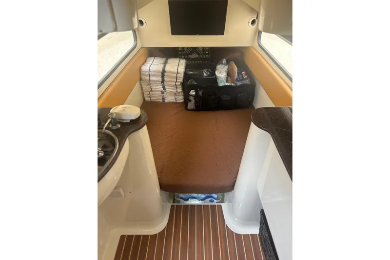  Yacht Photos Pics 2014 Scout 350 LXF cabin interior with bed, storage, and sink.