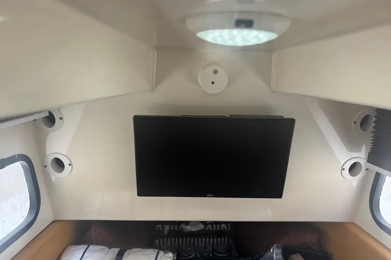  Yacht Photos Pics Interior cabin of a 2014 Scout 350 LXF boat with a mounted TV.