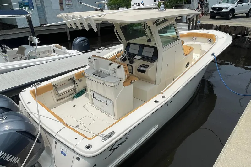  Yacht Photos Pics 2015 Scout 300 LXF boat docked, featuring dual Yamaha engines and advanced Garmin navigation.