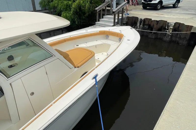  Yacht Photos Pics 2015 Scout 300 LXF boat docked, featuring sleek design and tan seating.