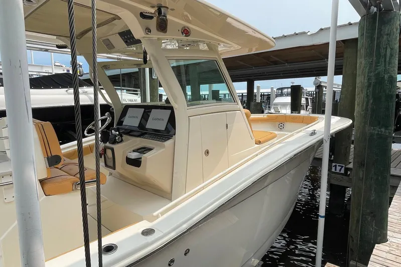  Yacht Photos Pics 2015 Scout 300 LXF boat docked, featuring dual Garmin displays and tan seating.
