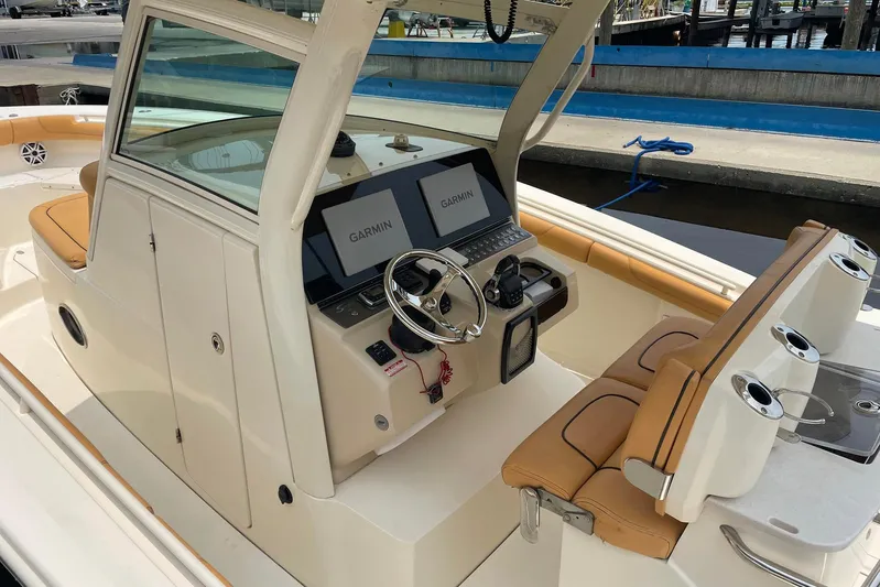  Yacht Photos Pics 2015 Scout 300 LXF boat interior with Garmin navigation system and tan seating.