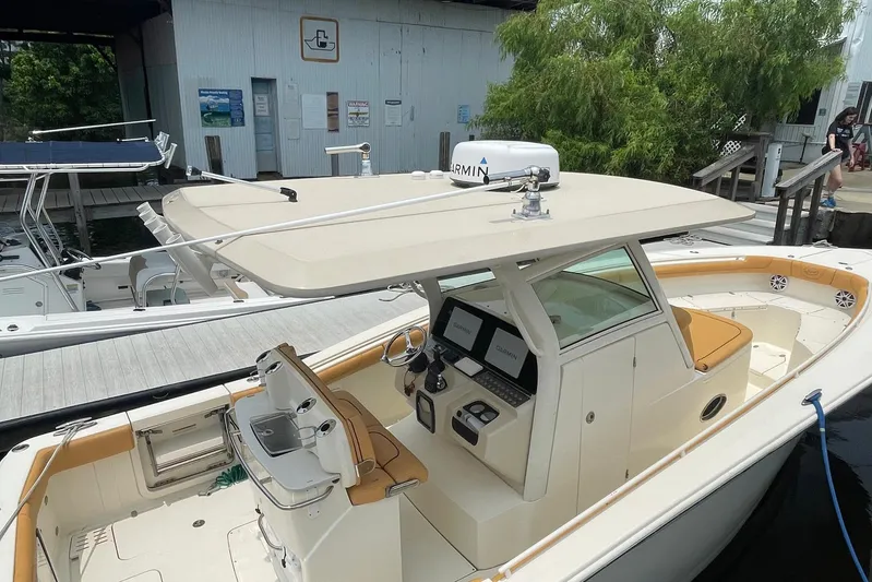  Yacht Photos Pics 2015 Scout 300 LXF boat docked, featuring a sleek design and modern navigation equipment.