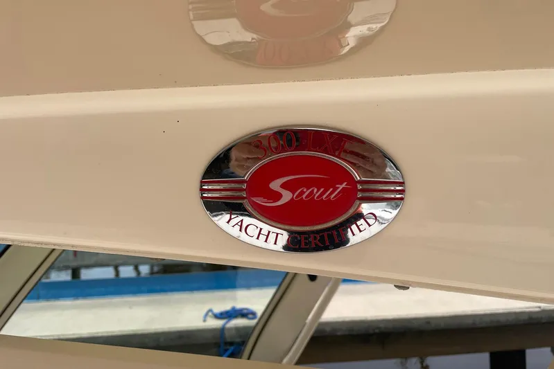  Yacht Photos Pics 2015 Scout 300 LXF yacht certified emblem on beige surface.