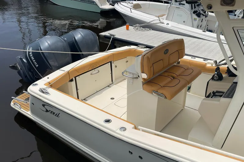  Yacht Photos Pics 2015 Scout 300 LXF boat with Yamaha engines, docked, featuring tan seating and sleek design.