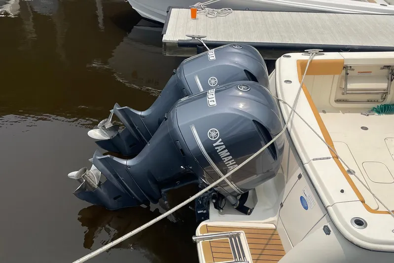  Yacht Photos Pics 2015 Scout 300 LXF boat with dual Yamaha outboard engines docked at marina.