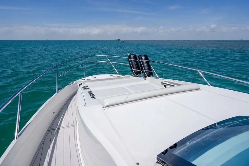 Yacht Photos Pics 2022 Regal 36 Grande Coupe yacht cruising on open sea under clear blue sky.