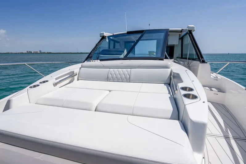  Yacht Photos Pics 2022 Regal 36 Grande Coupe yacht with luxurious sunbathing deck on open water.