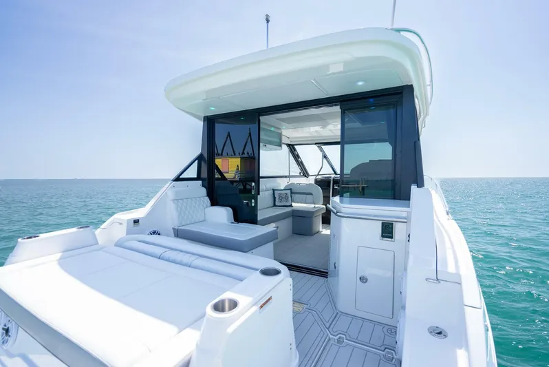  Yacht Photos Pics 2022 Regal 36 Grande Coupe yacht with spacious deck and luxurious interior on open water.