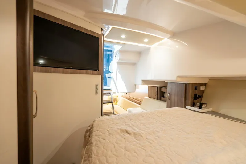  Yacht Photos Pics Interior of 2022 Regal 36 Grande Coupe, featuring a cozy cabin with a TV and modern amenities.