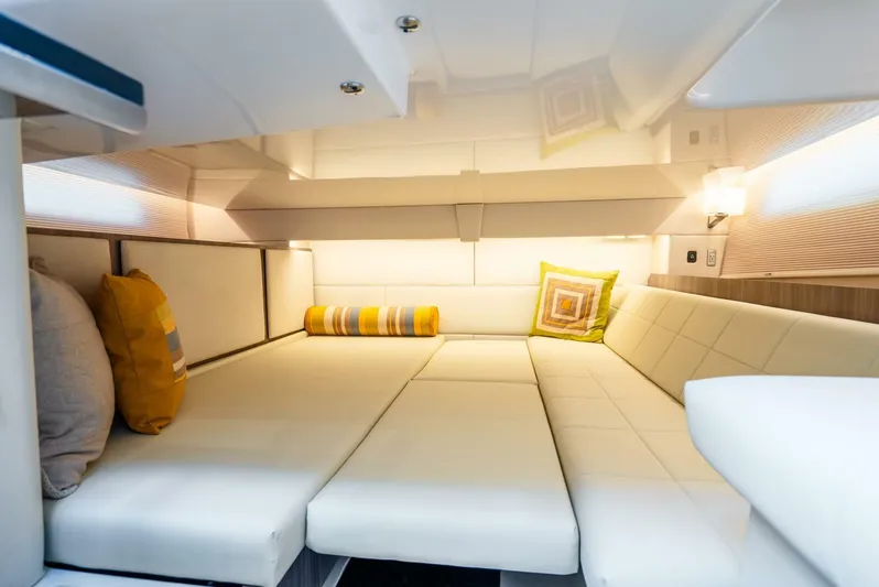  Yacht Photos Pics Luxurious interior of 2022 Regal 36 Grande Coupe with plush seating and decorative pillows.