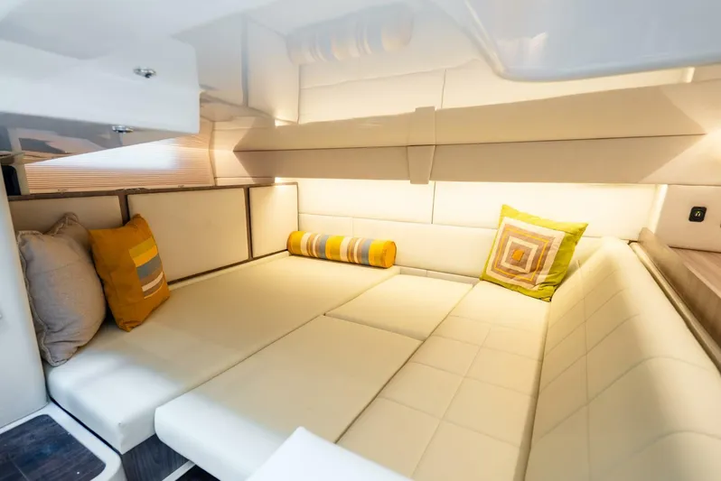  Yacht Photos Pics Luxurious interior of 2022 Regal 36 Grande Coupe with cozy seating and decorative pillows.