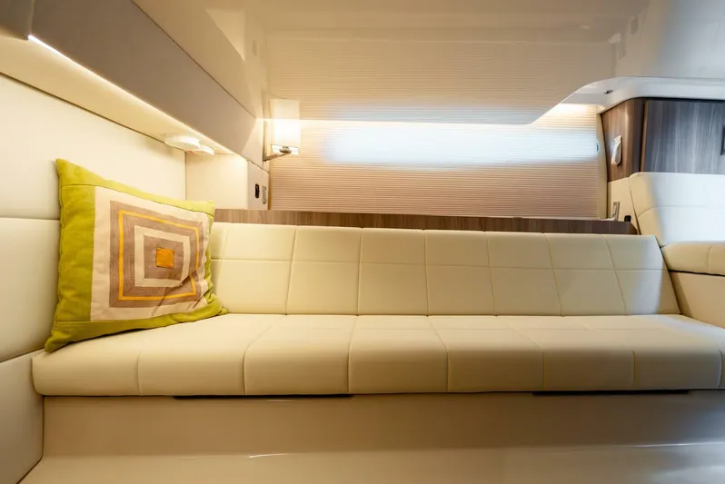  Yacht Photos Pics Luxurious interior of 2022 Regal 36 Grande Coupe with beige seating and decorative pillow.