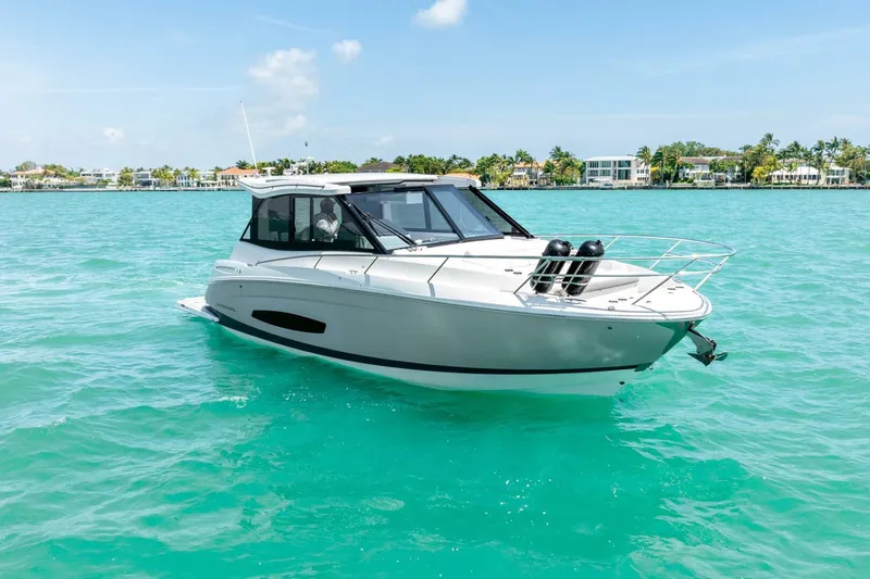  Yacht Photos Pics 2022 Regal 36 Grande Coupe yacht on turquoise water, clear sky background.
