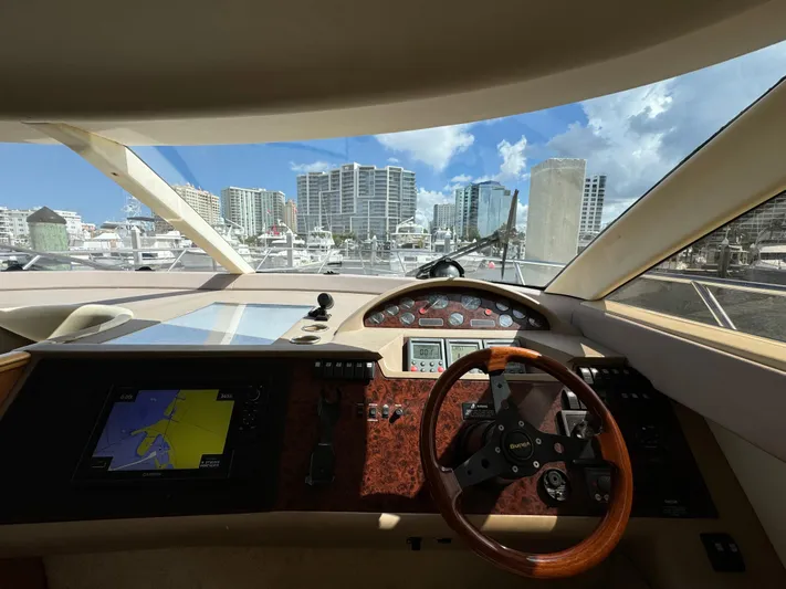 4 Aces Yacht Photos Pics 2001 Viking Princess 45 Flybridge yacht helm with city skyline view.