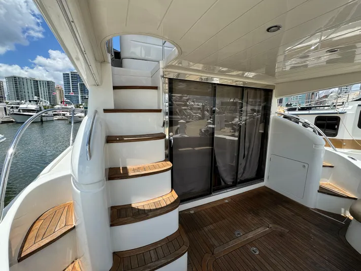 4 Aces Yacht Photos Pics 2001 Viking Princess 45 Flybridge yacht with wooden steps and marina view.