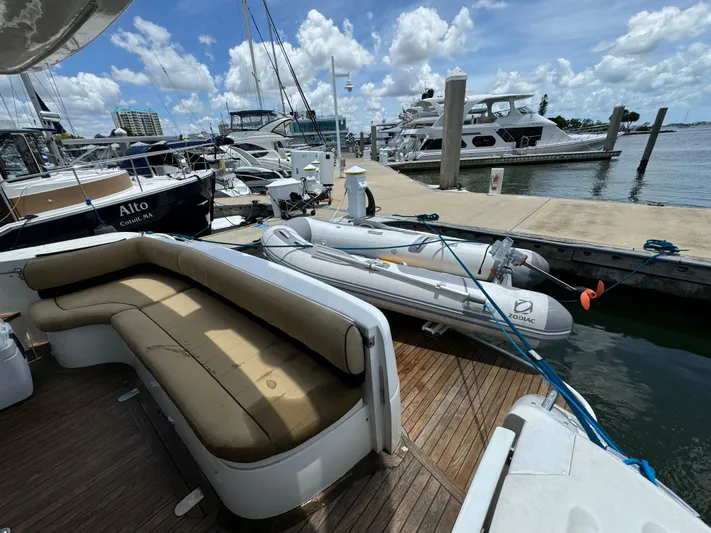 4 Aces Yacht Photos Pics Viking Princess 45 Flybridge 2001 yacht docked with tender boat, marina view.