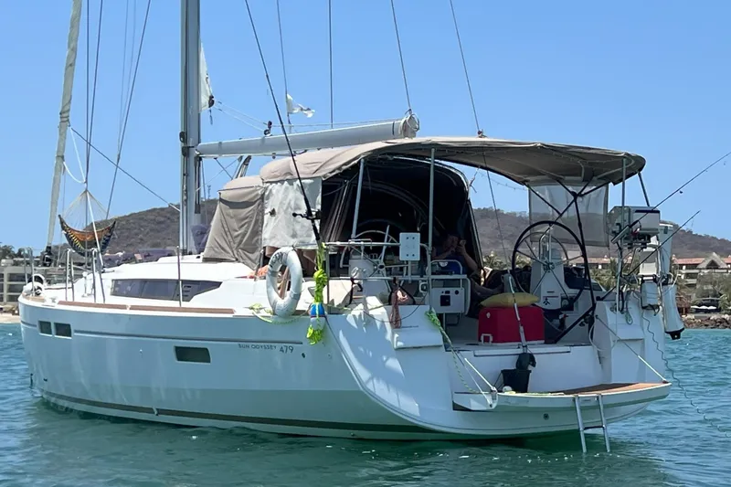 Victory Yacht Photos Pics 2018 Jeanneau Sun Odyssey 479 sailboat anchored in calm waters, featuring a spacious deck.