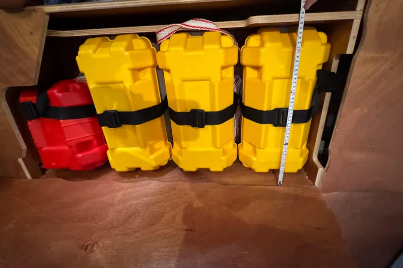 Victory Yacht Photos Pics Yellow and red storage containers secured in a Jeanneau Sun Odyssey 479 yacht, 2018 model.