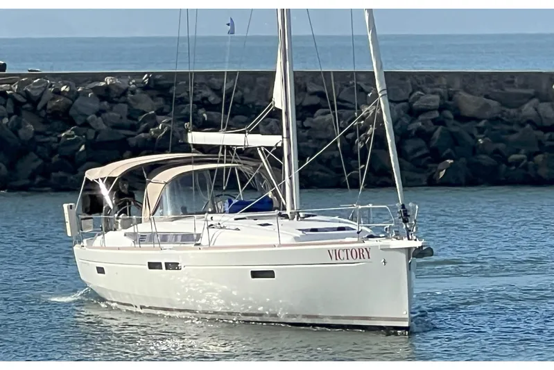 Victory Yacht Photos Pics 2018 Jeanneau Sun Odyssey 479 sailboat named "Victory" in a harbor setting.