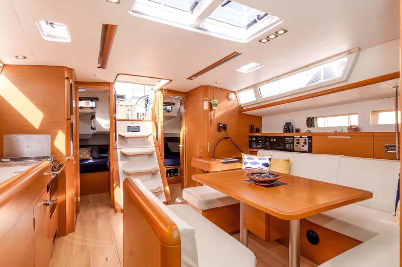 Victory Yacht Photos Pics Interior of 2018 Jeanneau Sun Odyssey 479 yacht, featuring modern wood finish and spacious seating.