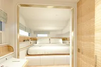 Luxurious yacht interior with modern design, featuring a cozy bedroom and stylish workspace.