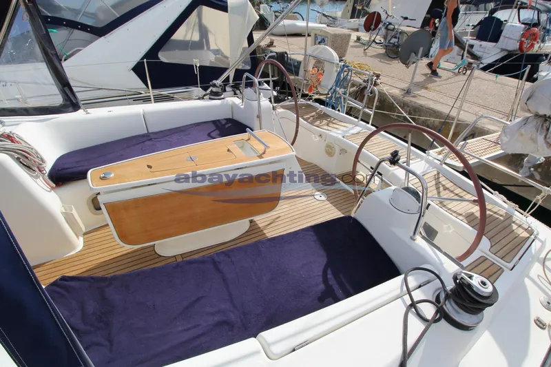  Yacht Photos Pics Cockpit of 2007 Beneteau Oceanis 43 yacht with dual steering wheels and wooden table.